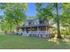 A beautiful two-story house with a spacious wrap-around porch and a large yard at 54 Malcolm Neal Path, Louisburg, NC 27549