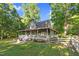 Charming two-story home with a wrap-around porch, white picket fence, and lush landscaping at 54 Malcolm Neal Path, Louisburg, NC 27549