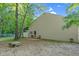 Exterior view of barn featuring a serene backyard with trees and greenery on a sunny day at 54 Malcolm Neal Path, Louisburg, NC 27549