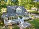 Back aerial view of a two-story home with a large wrap-around porch and patio at 54 Malcolm Neal Path, Louisburg, NC 27549