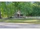Charming two-story home with a large front porch and lush, mature trees at 54 Malcolm Neal Path, Louisburg, NC 27549