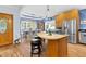 Open kitchen featuring wood cabinets, stainless steel refrigerator, and a cozy dining area at 54 Malcolm Neal Path, Louisburg, NC 27549