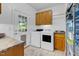 Functional laundry room with washer, dryer, sink, and a door leading to the outside at 54 Malcolm Neal Path, Louisburg, NC 27549