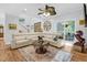 Bright living room with a large sectional sofa, decorative rug, and hardwood floors at 54 Malcolm Neal Path, Louisburg, NC 27549