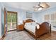 Calming bedroom with a ceiling fan, and private access to the screened in patio at 54 Malcolm Neal Path, Louisburg, NC 27549