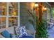 Inviting porch scene with wicker furniture, decorative pillows, and lush greenery at 54 Malcolm Neal Path, Louisburg, NC 27549