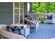 Inviting porch with wicker seating and blue-painted wood floors offers a relaxing outdoor space at 54 Malcolm Neal Path, Louisburg, NC 27549