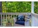 Relaxing porch seating featuring wicker chairs with comfortable cushions amidst a tranquil setting at 54 Malcolm Neal Path, Louisburg, NC 27549