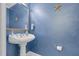 Striking powder room features a pedestal sink and beautiful paint at 54 Malcolm Neal Path, Louisburg, NC 27549