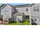 Townhome backyard view with green space, fence, patio access, and AC unit at 604 Oakfield Trl, Mebane, NC 27302