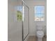 A bathroom with white tiled flooring, white walls, toilet and walk-in shower at 604 Oakfield Trl, Mebane, NC 27302