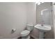 Clean half bath featuring a pedestal sink and modern fixtures at 604 Oakfield Trl, Mebane, NC 27302