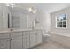 Bright bathroom with double sinks, tile floors, and a separate tub and shower at 604 Oakfield Trl, Mebane, NC 27302