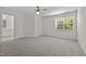 Large bedroom with ceiling fan, plush carpeting, and natural light, connecting to bathroom at 604 Oakfield Trl, Mebane, NC 27302