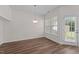 Dining area with wood floors, pendant lighting, and access to outdoor patio at 604 Oakfield Trl, Mebane, NC 27302