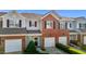 Charming townhome with a brick facade and attached one car garage at 604 Oakfield Trl, Mebane, NC 27302