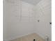 Bright laundry room featuring tile floors and wire rack shelving at 604 Oakfield Trl, Mebane, NC 27302
