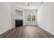 Cozy living room featuring a fireplace, ceiling fan, and wood-look floors at 604 Oakfield Trl, Mebane, NC 27302