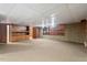 Finished basement featuring wood paneled walls, carpeting, and a spacious layout at 620 Mcghees Mill Rd, Roxboro, NC 27574