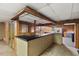 Basement wet bar featuring a black countertop with storage and tiled flooring at 620 Mcghees Mill Rd, Roxboro, NC 27574