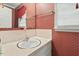 Traditional bathroom features vintage red patterned wallpaper and bright, neutral vanity at 620 Mcghees Mill Rd, Roxboro, NC 27574