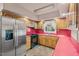 Retro kitchen with stainless steel fridge and bright red countertops at 620 Mcghees Mill Rd, Roxboro, NC 27574