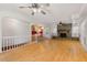 Open-concept living room with hardwood floors and a stone fireplace at 620 Mcghees Mill Rd, Roxboro, NC 27574