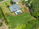Aerial view of a beautiful property with a large backyard and a sparkling pool surrounded by lush landscaping at 6208 Old Miravalle Ct, Raleigh, NC 27614