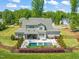 Aerial view of private backyard with a pool, jacuzzi, and landscaping at 6208 Old Miravalle Ct, Raleigh, NC 27614