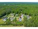 Aerial view of a meticulously landscaped property featuring a sparkling pool, lush lawn, and stately residence at 6208 Old Miravalle Ct, Raleigh, NC 27614