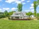 Expansive backyard features a well-manicured lawn, iron fencing and tasteful landscaping around a modern, gray two-story home at 6208 Old Miravalle Ct, Raleigh, NC 27614