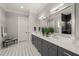 Bathroom highlighting dual sinks with a white countertop and framed mirrors, plus unique grey cabinetry at 6208 Old Miravalle Ct, Raleigh, NC 27614