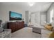Cozy bedroom retreat featuring a large TV, comfortable seating, and a well-lit, neutral color scheme at 6208 Old Miravalle Ct, Raleigh, NC 27614