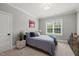 Inviting bedroom with a large window, natural light, and neutral color palette at 6208 Old Miravalle Ct, Raleigh, NC 27614