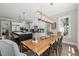 Open-concept dining area with modern lighting and furniture, seamlessly connected to the adjacent kitchen at 6208 Old Miravalle Ct, Raleigh, NC 27614