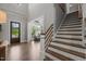 Inviting foyer with hardwood floors, staircase, and a view into the bright, open living area at 6208 Old Miravalle Ct, Raleigh, NC 27614