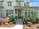 Charming brick home features a well-manicured lawn, colorful landscaping, and a welcoming front porch with grand entrance at 6208 Old Miravalle Ct, Raleigh, NC 27614