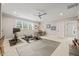 Bright home gym featuring modern exercise equipment, a ceiling fan, and natural light from a large window at 6208 Old Miravalle Ct, Raleigh, NC 27614