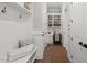 Hallway with white millwork, built-in shelves, decorative hooks, and a bench create an inviting transition space at 6208 Old Miravalle Ct, Raleigh, NC 27614