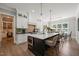 Well-appointed kitchen features a spacious island, stainless steel appliances, and a breakfast bar with seating at 6208 Old Miravalle Ct, Raleigh, NC 27614