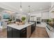 Gourmet kitchen featuring a large center island, stainless steel appliances, and seamless flow to the living spaces at 6208 Old Miravalle Ct, Raleigh, NC 27614