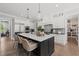 Modern kitchen featuring stainless steel appliances, a spacious island with seating, and stylish pendant lighting at 6208 Old Miravalle Ct, Raleigh, NC 27614