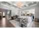 Open-concept living room featuring hardwood floors, coffered ceilings, and access to other rooms at 6208 Old Miravalle Ct, Raleigh, NC 27614
