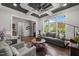 Spacious living room features large windows, coffered ceilings, and stylish, comfortable seating at 6208 Old Miravalle Ct, Raleigh, NC 27614