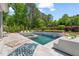 Serene backyard featuring a sparkling pool, comfortable lounge areas, and beautiful landscaping for ultimate relaxation at 6208 Old Miravalle Ct, Raleigh, NC 27614
