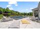 Luxurious backyard pool with a spa, lounge chairs, outdoor dining, and beautiful landscaping for relaxation at 6208 Old Miravalle Ct, Raleigh, NC 27614