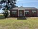 Charming brick home with symmetrical design and vintage window awnings at 6555 Nc 58, Nashville, NC 27856