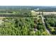 Aerial view of property showcasing home among dense trees and its location near a highway at 726 Thomas Rd, Rocky Mount, NC 27801