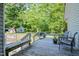 Relax on the wooden back deck surrounded by lush greenery, perfect for outdoor entertaining at 726 Thomas Rd, Rocky Mount, NC 27801