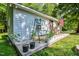 Charming back porch featuring a wooden swing, potted plants, and American flag at 726 Thomas Rd, Rocky Mount, NC 27801